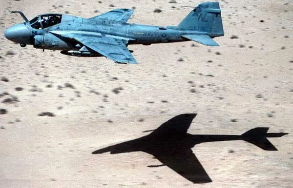 A-6 Intruder low-level over the desert with its shadow