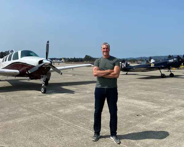 Paco on the ramp with a Beechcraft Bonanza and Yak-52