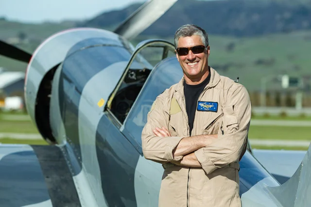 Paco Chierici in a flight suit beside an aircraft